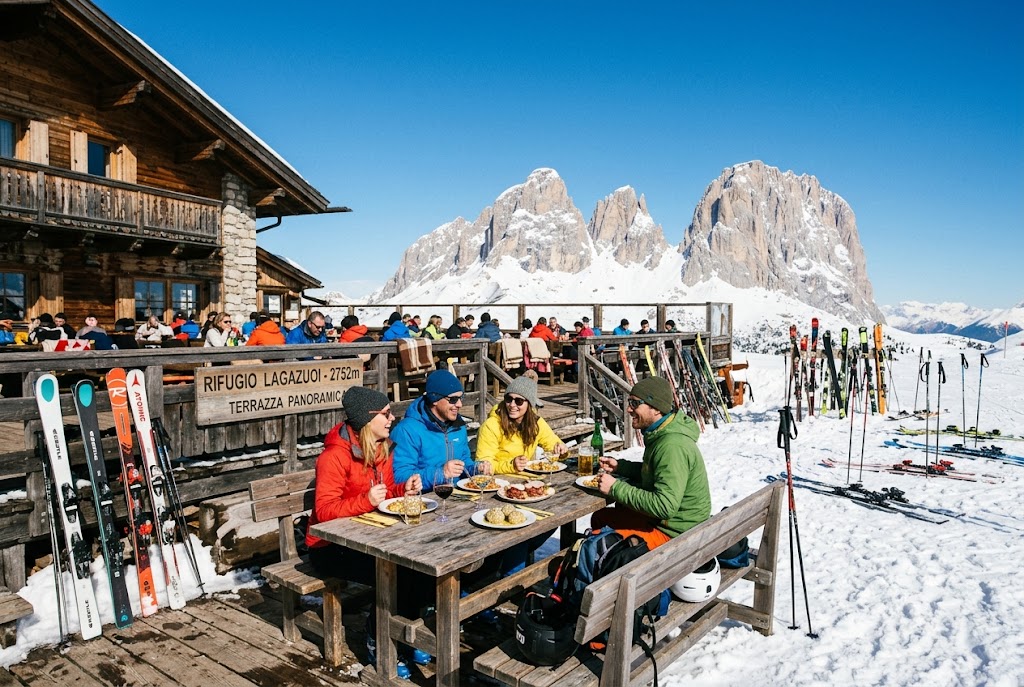 A ski lunch in the Alps at Rifugio Lagazuoi, with diners eating on a sunny terrace and skis lined up in the snow
